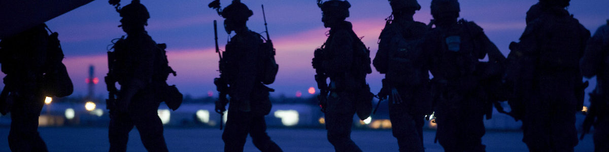 Silhouettes of Marines in front of a sunset